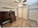 Bedroom with wood-look flooring, built-in desk, and a ceiling fan offers comfort and style at 3810 N 106Th Dr, Avondale, AZ 85392