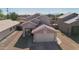 Exterior of a home with a well-kept lawn, two car garage and neutral earth tone colors at 3810 N 106Th Dr, Avondale, AZ 85392