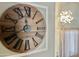 Foyer boasts a decorative wooden clock, modern chandelier, and floods of natural light at 3810 N 106Th Dr, Avondale, AZ 85392