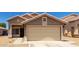 Inviting exterior showcasing a two-car garage, neutral paint, and low maintenance landscaping at 3810 N 106Th Dr, Avondale, AZ 85392