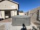 Covered hot tub in a fenced-in backyard with gravel landscaping and building in background at 3810 N 106Th Dr, Avondale, AZ 85392