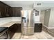 Modern kitchen features stainless steel appliances, granite countertops and dark wood cabinetry at 3810 N 106Th Dr, Avondale, AZ 85392