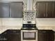 Gourmet kitchen with stainless steel appliances, custom backsplash, and granite countertops at 3810 N 106Th Dr, Avondale, AZ 85392