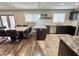 Open-concept kitchen with dark cabinetry, granite countertops, and a center island with seating at 3810 N 106Th Dr, Avondale, AZ 85392