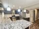 Spacious kitchen features stainless steel appliances, granite counters, and stylish pendant lighting at 3810 N 106Th Dr, Avondale, AZ 85392