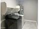Well-equipped laundry room featuring gray floors, a Samsung washer and dryer, and a modern water heater system at 3810 N 106Th Dr, Avondale, AZ 85392