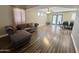 Open-concept living and dining area with a grey, tufted sectional sofa and plenty of room at 3810 N 106Th Dr, Avondale, AZ 85392