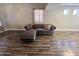 Large living room with a comfortable grey, tufted sectional sofa and natural light at 3810 N 106Th Dr, Avondale, AZ 85392