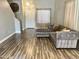 Inviting living room with a grey, tufted sectional sofa, stairs, and neutral decor at 3810 N 106Th Dr, Avondale, AZ 85392