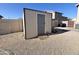 Utility shed in a fenced-in backyard with gravel landscaping at 3810 N 106Th Dr, Avondale, AZ 85392
