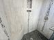 This upgraded shower features a modern tile, comfortable bench, handheld fixture, and inset shelf that offers a spa-like experience at 3810 N 106Th Dr, Avondale, AZ 85392