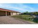 The expansive backyard features a well-maintained lawn and a charming brick patio for outdoor enjoyment at 3844 E Shomi St, Phoenix, AZ 85044