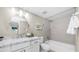 Bright bathroom featuring a granite-topped vanity, round mirror, and a tiled shower-over-tub combo at 3844 E Shomi St, Phoenix, AZ 85044