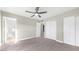 This bedroom boasts carpet, a ceiling fan, closet, and an adjacent bathroom with a white-tiled shower at 3844 E Shomi St, Phoenix, AZ 85044