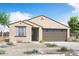 Inviting single-story home with neutral stucco, desert landscaping, and a two-car garage at 3907 S 241St Ln, Buckeye, AZ 85326