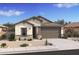 Charming single-story home with a two-car garage and beautiful desert landscaping in the front yard at 42400 W Peters Dr, Maricopa, AZ 85138