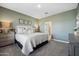 Comfortable main bedroom with calming paint, a cozy bed, and stylish bedside tables at 42400 W Peters Dr, Maricopa, AZ 85138