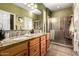 Well-lit bathroom with double sinks, granite countertops, and a walk-in shower at 4637 E Narrowleaf Dr, Gilbert, AZ 85298