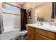 Bright bathroom showcasing a clean vanity, framed mirror, and shower with white tile at 4637 E Narrowleaf Dr, Gilbert, AZ 85298