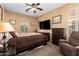 Comfortable bedroom with neutral tones, plush carpet, and a modern ceiling fan at 4637 E Narrowleaf Dr, Gilbert, AZ 85298