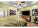Bright bedroom with wood flooring, TV, and easy access to the bathroom at 4637 E Narrowleaf Dr, Gilbert, AZ 85298