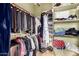 Walk-in closet with clothing racks, shelves, and ample storage space at 4637 E Narrowleaf Dr, Gilbert, AZ 85298