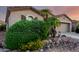 Beautifully landscaped front exterior featuring lush greenery and vibrant yellow flowers at 4637 E Narrowleaf Dr, Gilbert, AZ 85298