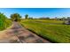 Scenic golf course view with a paved path and golf cart at 4637 E Narrowleaf Dr, Gilbert, AZ 85298
