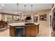 Kitchen island with sink and stainless steel dishwasher, adjacent to a cozy living space at 4637 E Narrowleaf Dr, Gilbert, AZ 85298