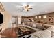 Open-concept living room with hardwood floors, flowing into the dining and kitchen areas at 4637 E Narrowleaf Dr, Gilbert, AZ 85298
