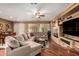 Spacious living room featuring hardwood floors, a fireplace, and ample seating at 4637 E Narrowleaf Dr, Gilbert, AZ 85298