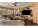 Comfortable living area with hardwood floors, built-in shelving, and a cozy fireplace at 4637 E Narrowleaf Dr, Gilbert, AZ 85298