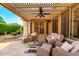Inviting covered patio with ample seating, stone floors and overhead fan for relaxing and entertaining at 4637 E Narrowleaf Dr, Gilbert, AZ 85298