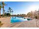 Sparkling pool surrounded by palm trees, offering a refreshing oasis for relaxation and recreation at 4637 E Narrowleaf Dr, Gilbert, AZ 85298