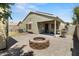 Backyard featuring an outdoor kitchen and sitting area with a fire pit at 5026 S 235Th Dr, Buckeye, AZ 85326