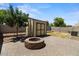 Backyard with a shed and brick fire pit at 5026 S 235Th Dr, Buckeye, AZ 85326