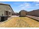 View of backyard featuring a shed and grill at 5026 S 235Th Dr, Buckeye, AZ 85326