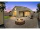 Backyard with a stone fire pit, perfect for outdoor entertaining and relaxation at 5026 S 235Th Dr, Buckeye, AZ 85326