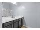 Modern bathroom with a spacious countertop, vanity, and mirror at 5026 S 235Th Dr, Buckeye, AZ 85326