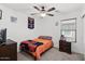 Comfortable bedroom with sports memorabilia and a ceiling fan at 5026 S 235Th Dr, Buckeye, AZ 85326