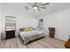 Bright, spacious bedroom with ceiling fan, neutral walls, and wood-look floors at 5026 S 235Th Dr, Buckeye, AZ 85326