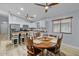 Open kitchen/dining area with ample natural light and wood-look floors at 5026 S 235Th Dr, Buckeye, AZ 85326