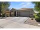 Charming home featuring a two-car garage and desert landscaping at 5026 S 235Th Dr, Buckeye, AZ 85326