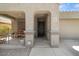 Covered front entrance with decorative columns leading to a charming front door at 5026 S 235Th Dr, Buckeye, AZ 85326