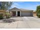 Charming single-story home with a well-maintained front yard and a two car attached garage at 5026 S 235Th Dr, Buckeye, AZ 85326