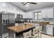Spacious kitchen featuring a central island with seating, stainless appliances, and sleek countertops at 5026 S 235Th Dr, Buckeye, AZ 85326