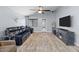 Spacious living room with modern furniture and decor, including a large TV at 5026 S 235Th Dr, Buckeye, AZ 85326