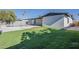 Spacious backyard featuring lush green grass, a pool, and a home with a modern design for outdoor enjoyment at 5028 W Shangri La Rd, Glendale, AZ 85304