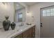 Bathroom featuring dual sinks, marble countertop, stylish fixtures, and a door to the outside at 5028 W Shangri La Rd, Glendale, AZ 85304