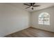 A bright bedroom with wood floor and arched window at 5028 W Shangri La Rd, Glendale, AZ 85304